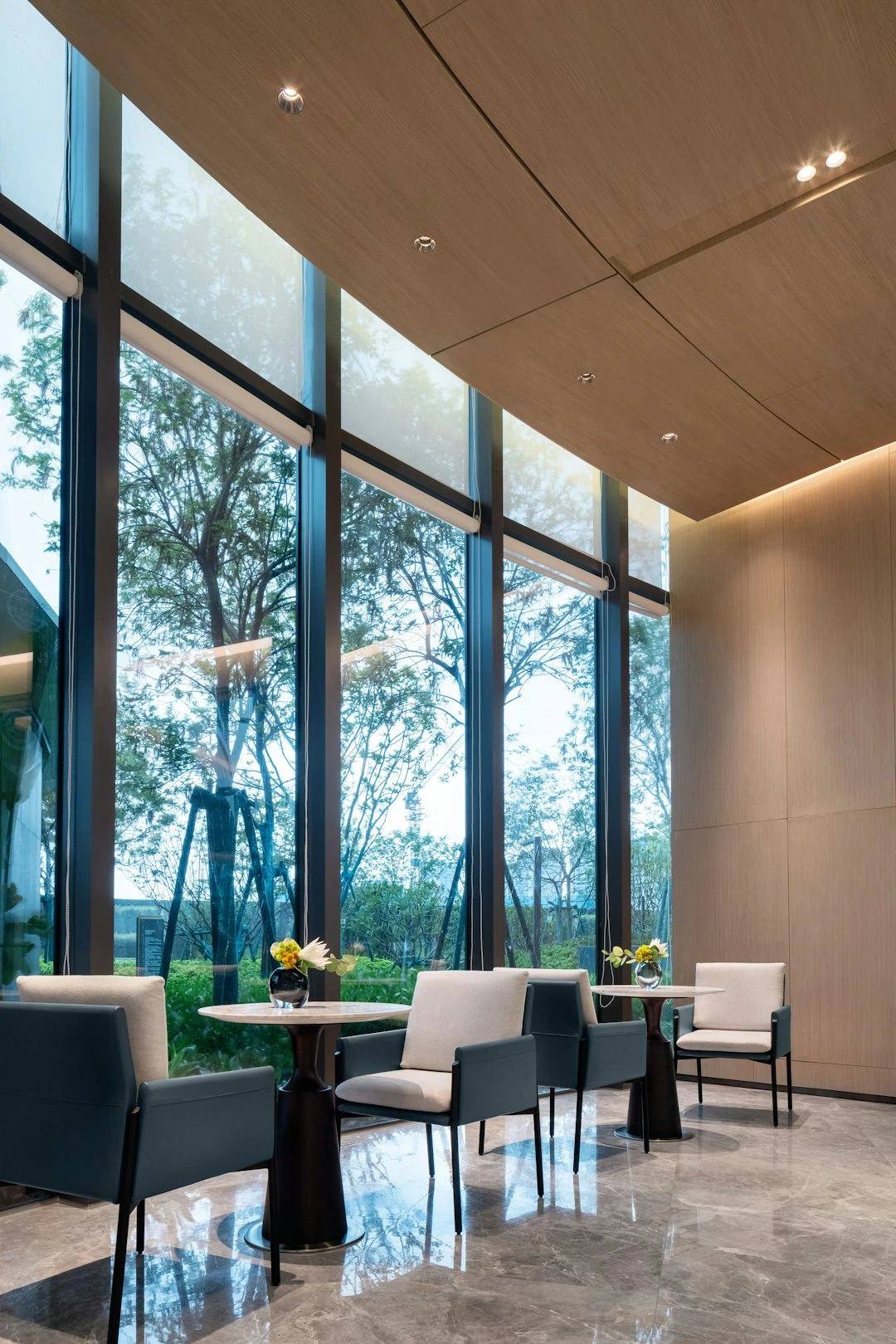 Modern lounge area with tall windows and outdoor view